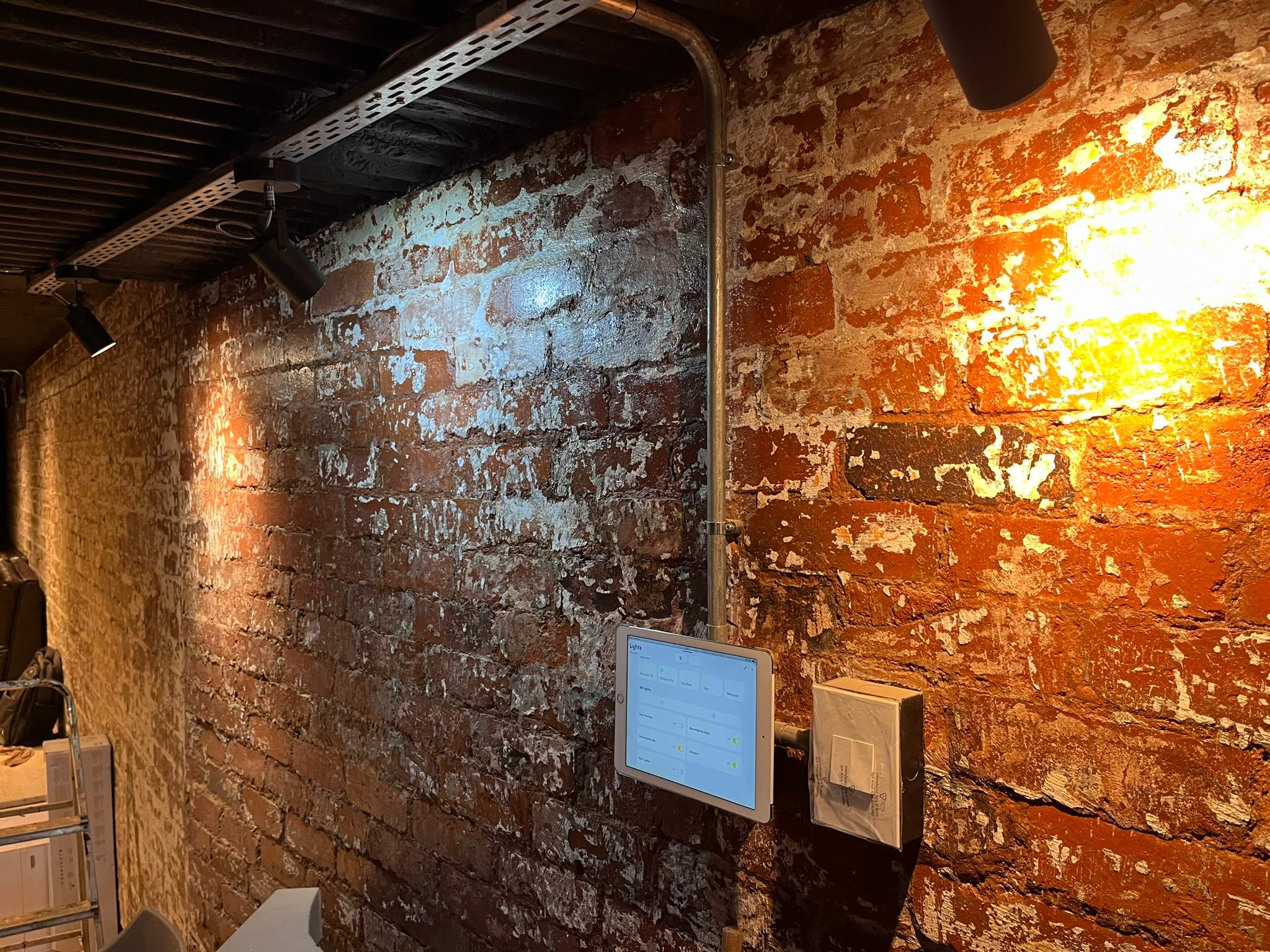 Crestron touch panel and iPad control showing smart home scenes with manual control options