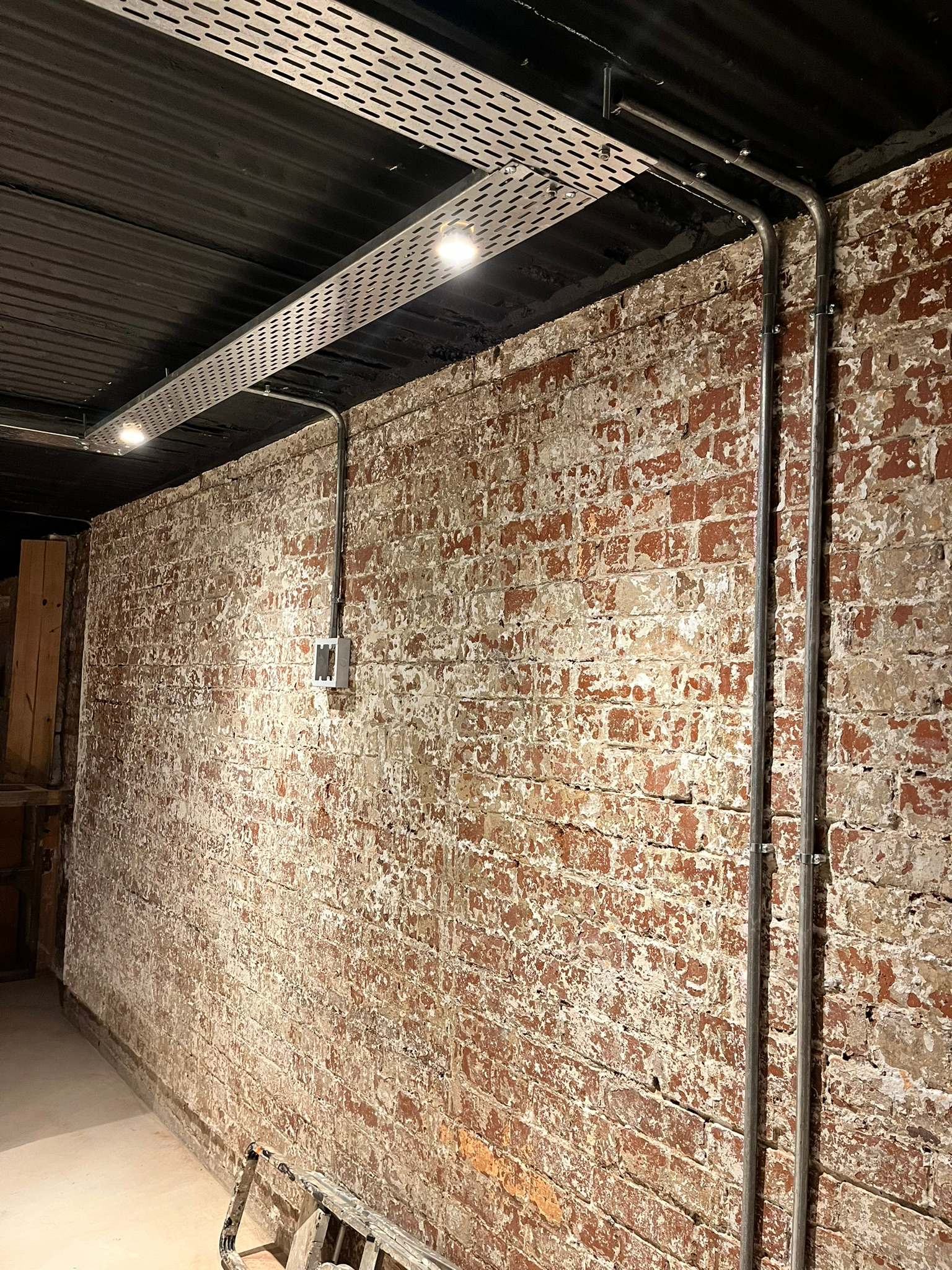 DG Technologies heritage entertainment room build detail: Exposed Metal Conduit Detail